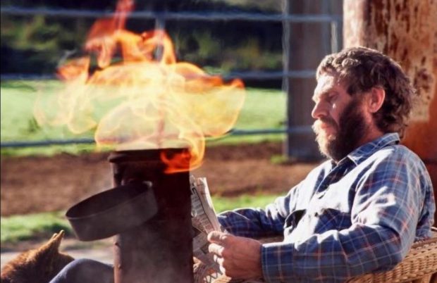 Steve McQueen having coffee, reading a newspaper, and enjoying an open fire in a lit smudge pot in the backyard of his Santa Paula home. Barbara Minty McQueen said it was his favorite part of the day. She took this last photo of him in the late spring of 1980. (Courtesy Barbara Minty McQueen)